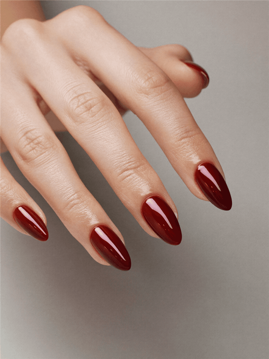 A bold cherry-red manicure previewed on a real hand with Naura